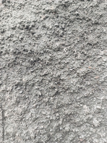 Natural stone wall with rugged stacked brown and grey rocks, perfect for construction background, rustic themes, and architectural surfaces