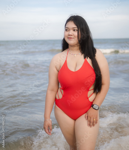 Woman young portrait asian fat chubby cute beautiful smile cheerful happy fun enjoy relax freedom in bikini swimwear body sexy plus size stand sea beach sunset ocean summer travel holiday evening time