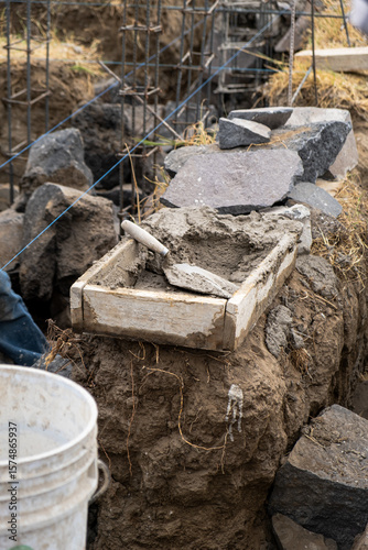 Wallpaper Mural Close-up of a wooden trough with cement mortar and a trowel, construction tools in Mexico Torontodigital.ca
