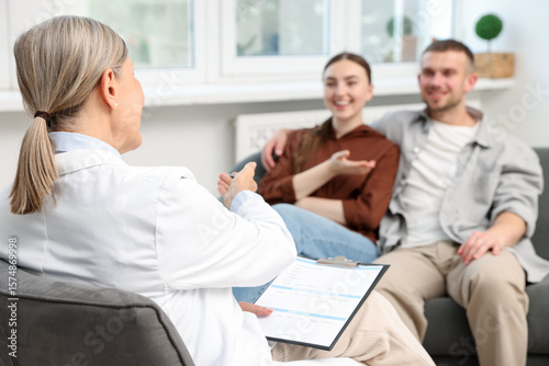In vitro fertilization (IVF). Couple having consultation with doctor in reproductive clinic, selective focus