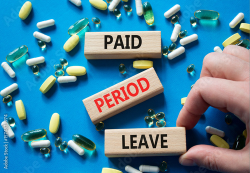 Paid Period Leave symbol. Concept words Paid Period Leave on wooden blocks. Beautiful blue background with pills. Doctor hand. Healthcare and Paid Period Leave concept. Copy space.