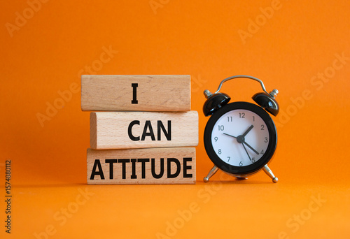 I Can Attitude symbol. Wooden blocks with words I Can Attitude. Beautiful orange background with alarm clock. Business and I Can Attitude concept. Copy space.