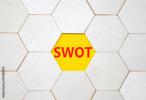 SWOT symbol. Concept word SWOT on wooden comb puzzle. Beautiful yellow background. Business and SWOT concept. Copy space.