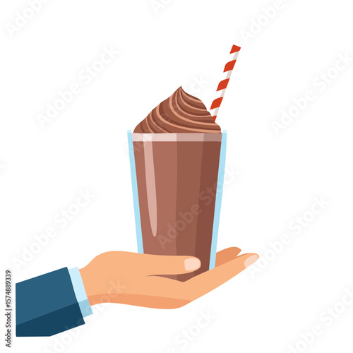 A hand holding a delicious chocolate shake in a glass with a straw 