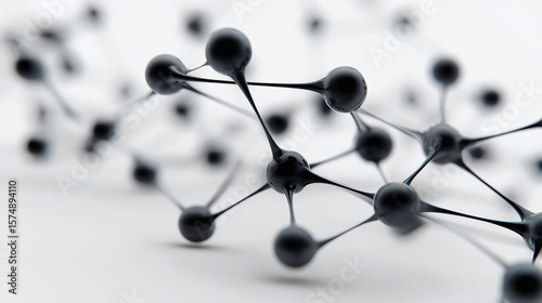 Abstract black network of connected spheres on a light background representing data or neural systems.
