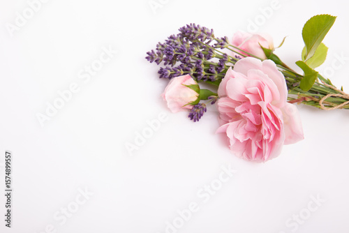 Pink rose and lavender bouquet with craft tag on white background, floral composition with copy space, elegant botanical layout for wedding invitation, birthday greeting, packaging, spa concept
