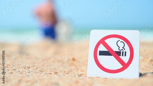No Smoking sign. Smoking is prohibited in public places. Prohibitory sign against the background of sand and sea, ocean. Attention, smoking is prohibited.