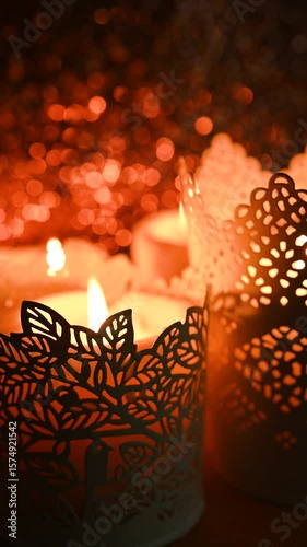 Interior decor and festive coziness, stock video. Burning candles in decorative candlesticks against sparkling bokeh background, selective focus.