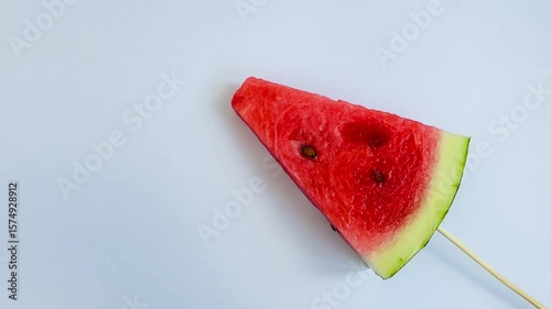a slice of fresh watermelon on a stick