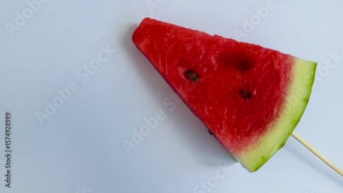 a slice of fresh watermelon on a stick