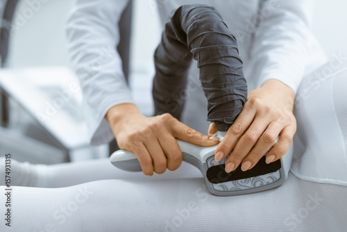 Detailed view of therapist performing LPG massage with specialized equipment on a client's body for relaxation and wellness