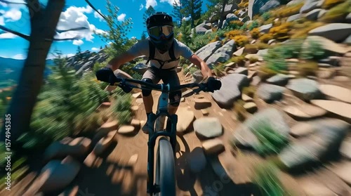 Mountain biker navigates rocky trail under blue sky during daytime adventure