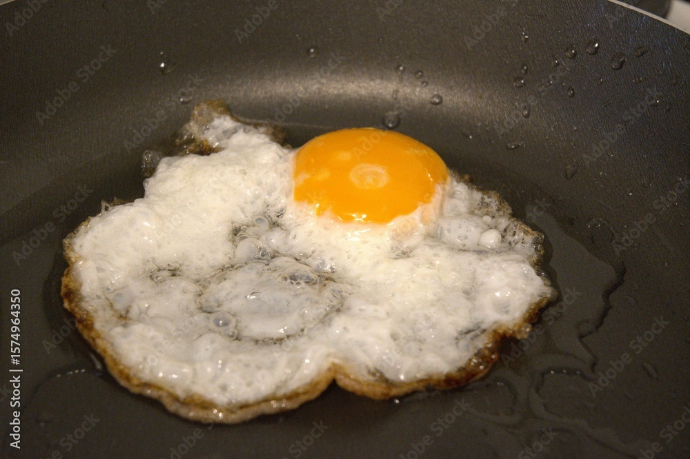 One fried egg in the pan close up One fried egg in the pan close up