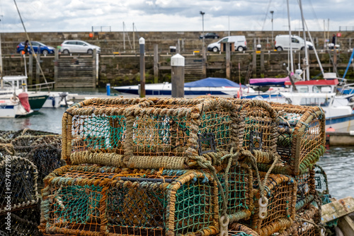 Crab pots, lobster pots and fishing traps on the quayside and harbour wall in the seaside town of Scarborough