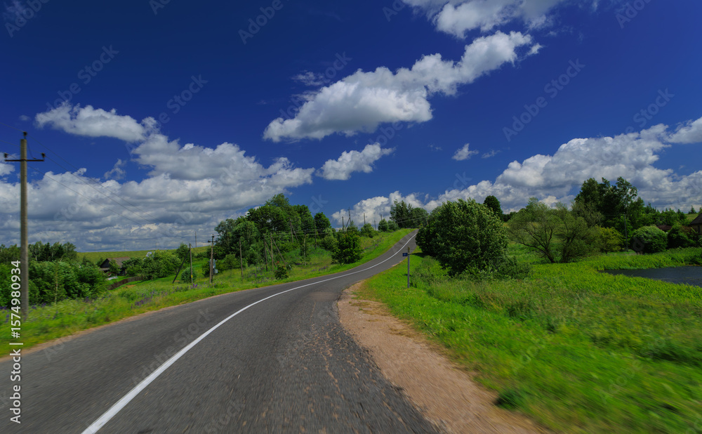 Naklejka premium Road view on a summer day. Highways, roadside and white road line markings.