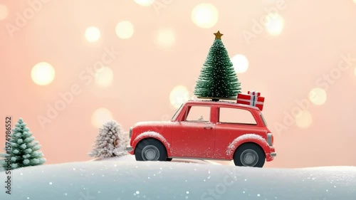 A small red toy car carries a Christmas tree and presents on its roof. The scene is set in a snowy landscape with soft bokeh lights in the background.