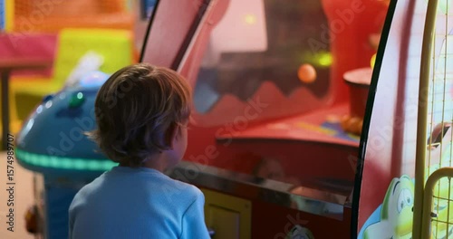 Child Playing Arcade Game in Colorful Entertainment Center
