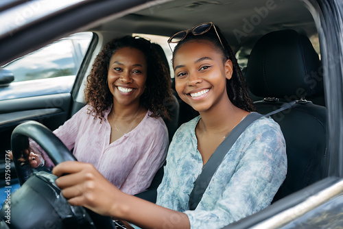 Smiling mother and daughter enjoying a car ride together on a sunny day