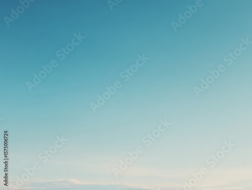 Fototapeta Naklejka Na Ścianę i Meble -  Minimal pale blue gradient sky with few clouds and soft cinematic light.