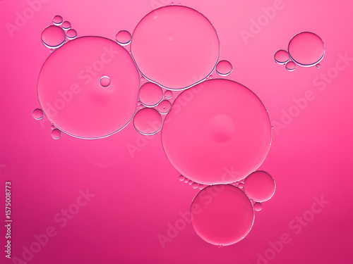 Oil bubbles. Oil bubbles on water in pink tones close-up. Abstract texture