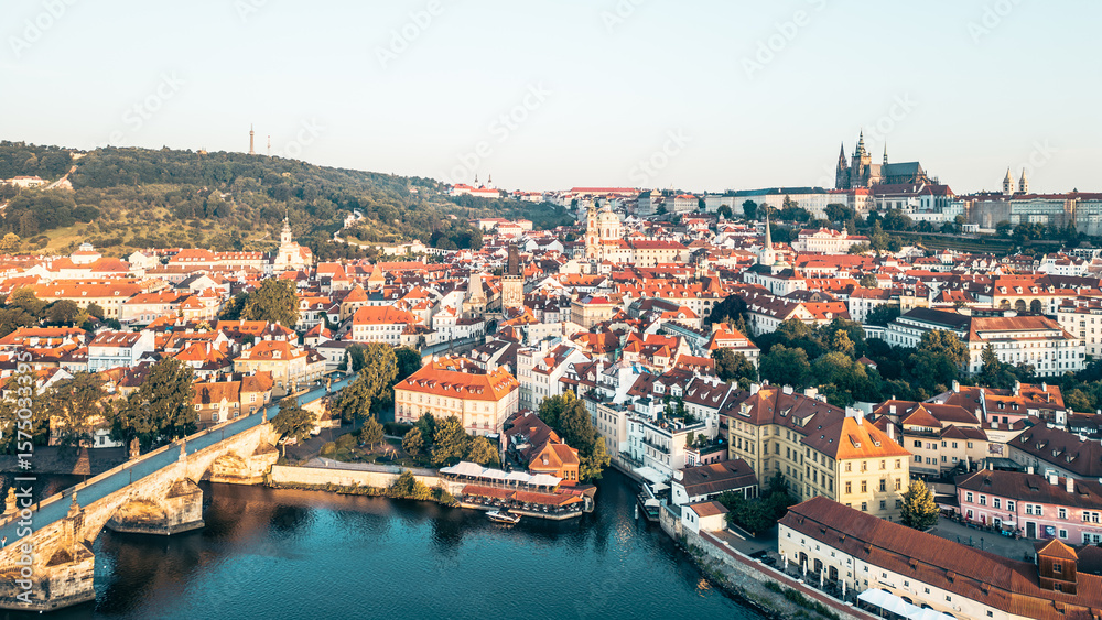 Aerial view capturing the beauty of Prague at sunrise, showcasing the Charles Bridge and Hradcany Castle bathed in morning light, with no people in sight. Aerial view capturing the beauty of Prague at sunrise, showcasing the Charles Bridge and Hradcany Castle bathed in morning light, with no people in sight.