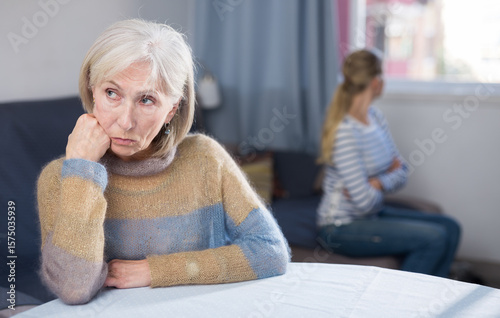 Young daughter angry with elderly mother at home