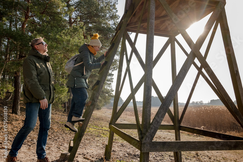Dad And Daughter Walking In The Forest Near The Lookout Tower In Spring