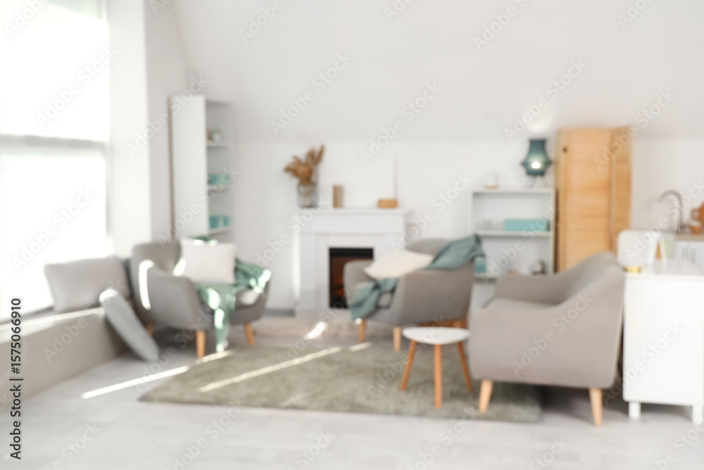 Fototapeta premium Blurred view of living room with armchairs and fireplace
