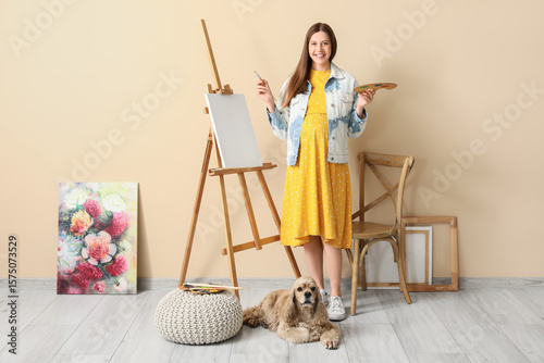 Young pregnant artist with ...