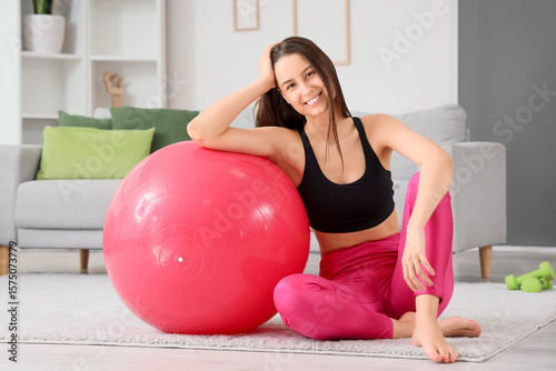 Sporty young woman sitting ...