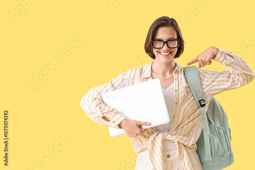 Happy female student with b...
