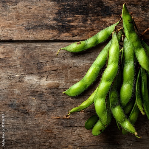 Fresh green edamame pods arranged on a rustic wooden surface showcase a healthy snack option and natural, unprocessed food ingredient for a balanced diet.