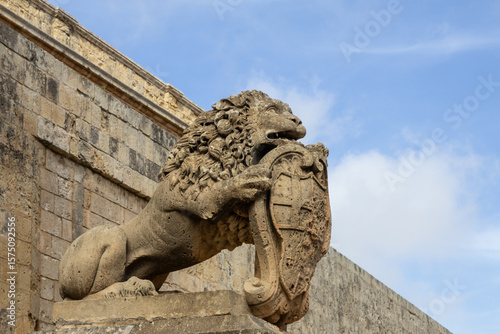 stone lion statue guarding the main gates of Mdina City, Malta