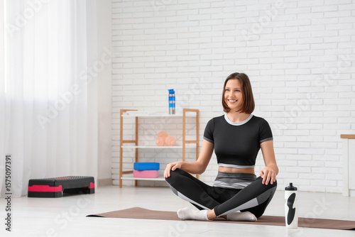 Sporty young woman sitting ...
