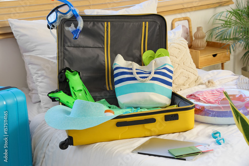 Open suitcase, laptop and b...