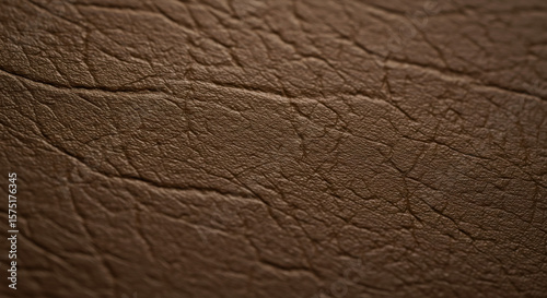 Macro shot of natural leather texture showing pores and grain in warm brown tones