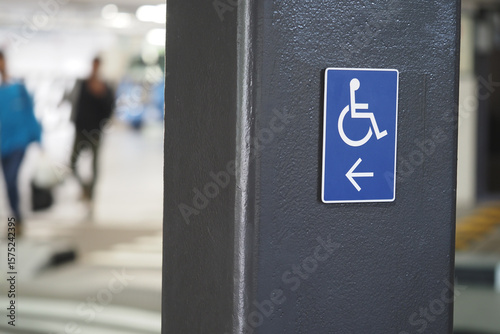 Parking sign indicating accessible space in busy area