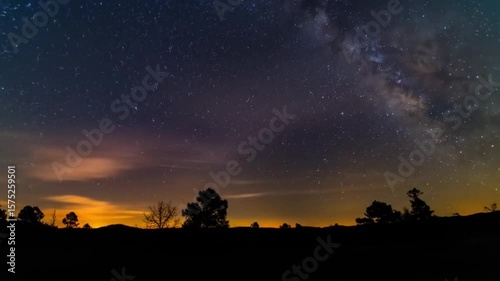 Starry night sky meets sunrise silhouettes
