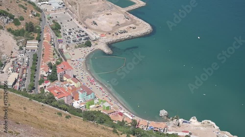 Summer view of Catalan Bay in Gibraltar with beach and large parking lot
