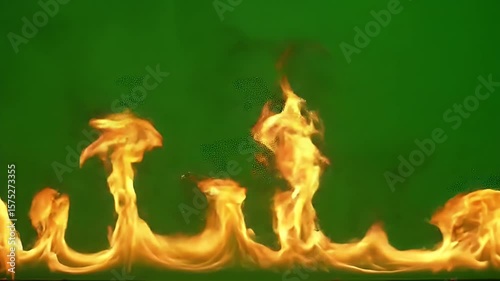 Dramatic flames rising with dynamic motion on vibrant green background