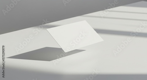 Photo of blank white business card floating in light