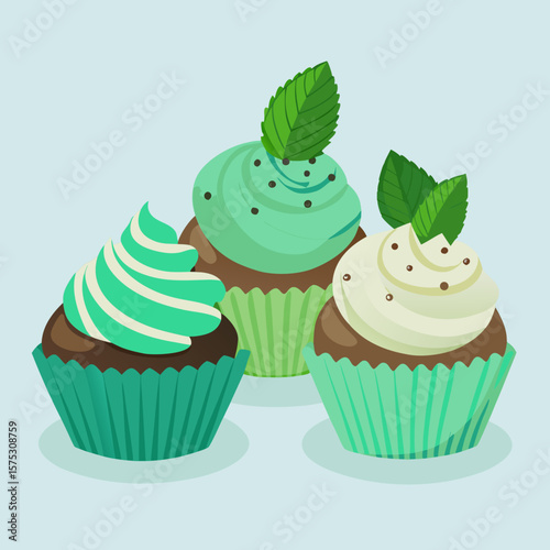 Three delicious mint flavored cupcakes with fresh mint leaves and chocolate sprinkles