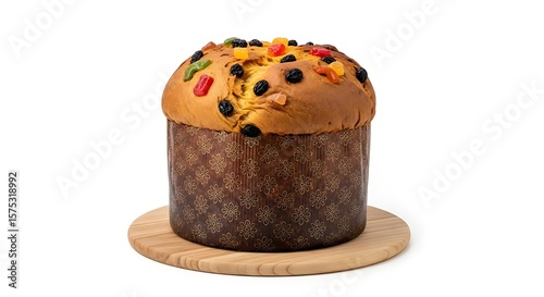 Close up of a panettone cake with candied fruit on a wooden cutting board
