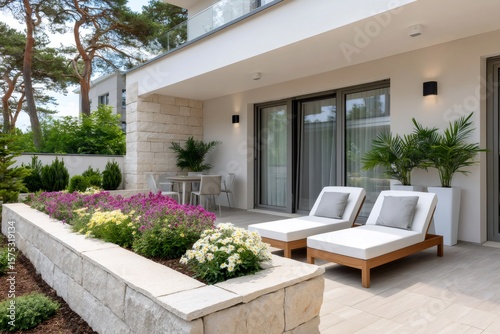 Modern patio with deck chairs inviting to relax in front of a beautiful house