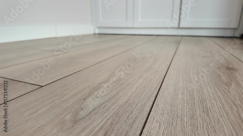 light brown laminate flooring in a room with white cabinets