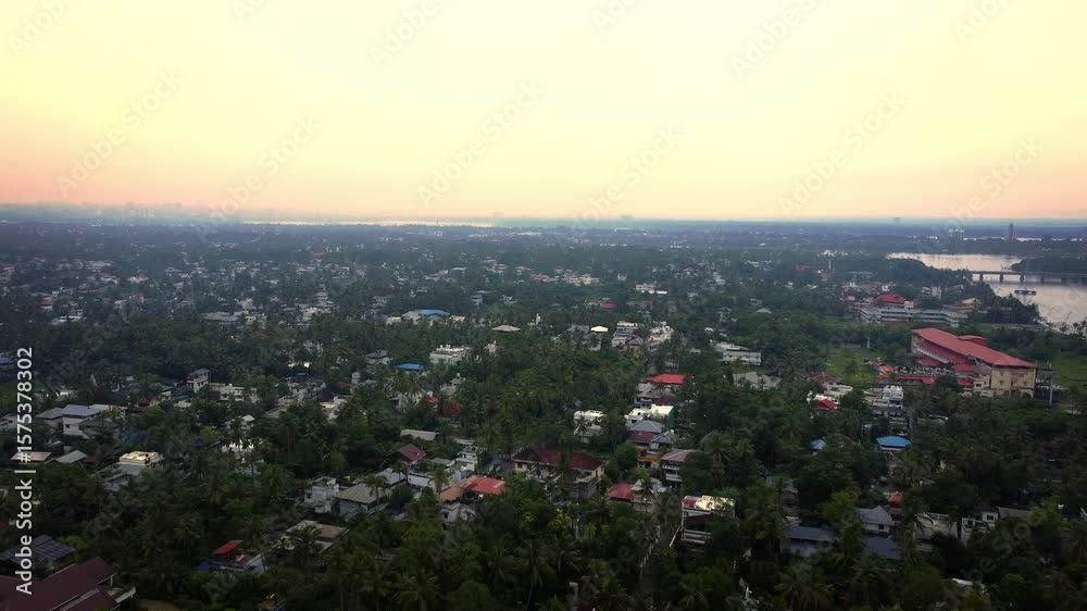 Aerial drone shot of Kochi city, Kerala, India — showcasing a mix of urban infrastructure, residential neighborhoods, and abundant greenery near the scenic backwaters Aerial drone shot of Kochi city, Kerala, India — showcasing a mix of urban infrastructure, residential neighborhoods, and abundant greenery near the scenic backwaters