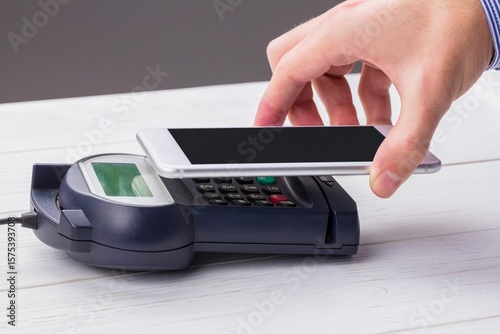 Man using smartphone to express pay