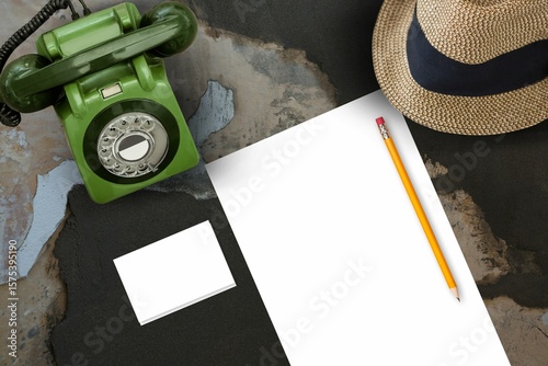 Paper in front of hat and phone on a old table