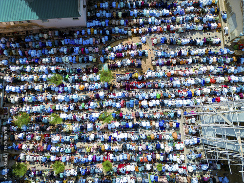 Kaduna, Nigeria - 06 December 2025: Aerial view of a sea of worshippers adorned in white and blue, a vibrant tapestry under the soft, diffused sunlight, gathered in prayerful unity.