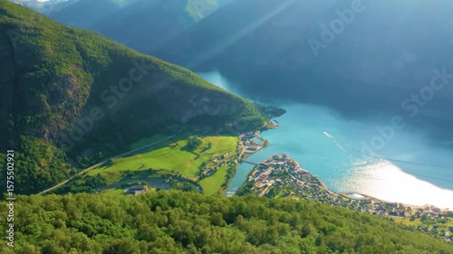 Aerial View of Mountain Village by Blue Lake Surrounded by Green Hills – Scenic Landscape in Summer